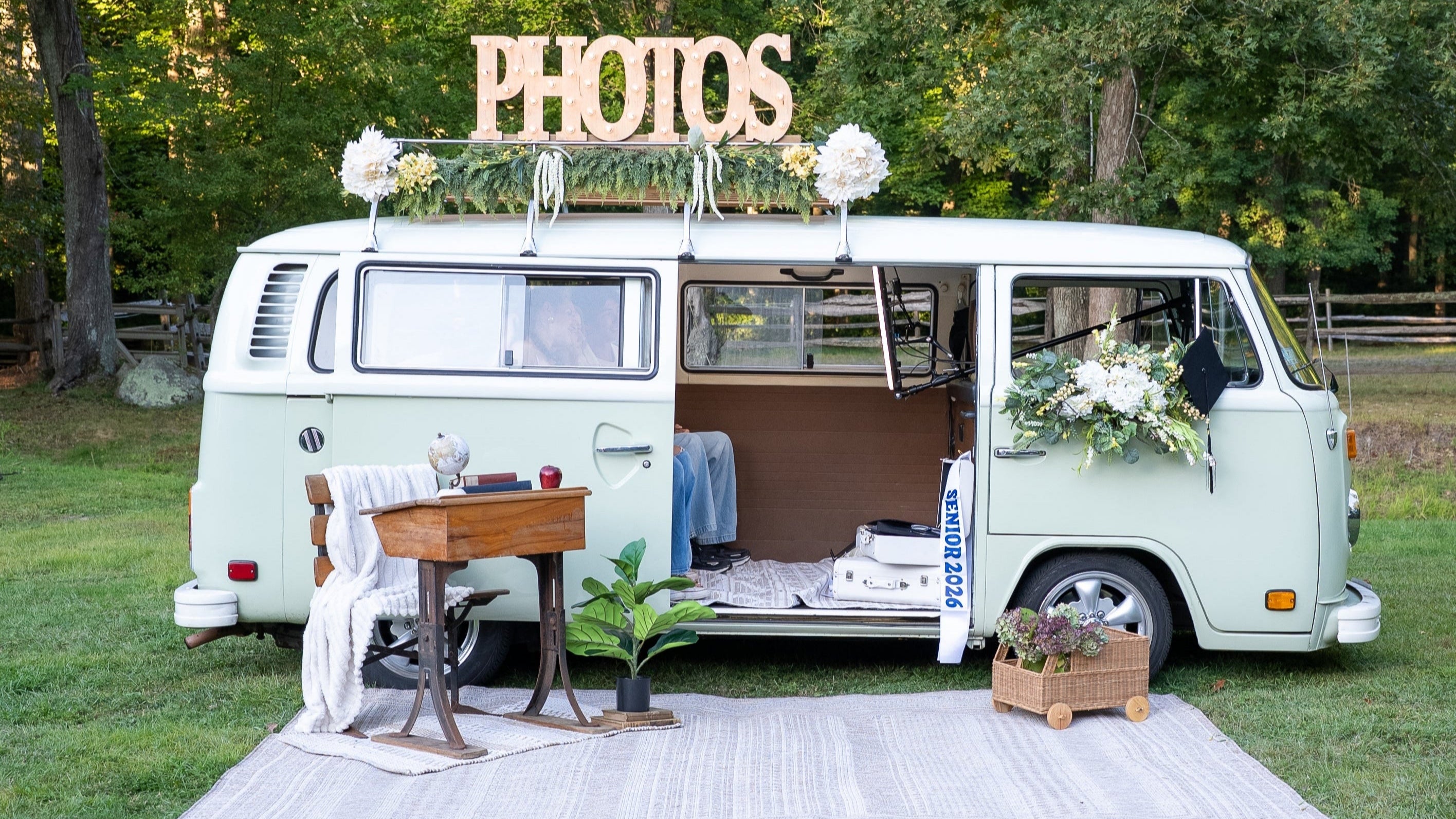 Green VW bus photo booth prop in a field