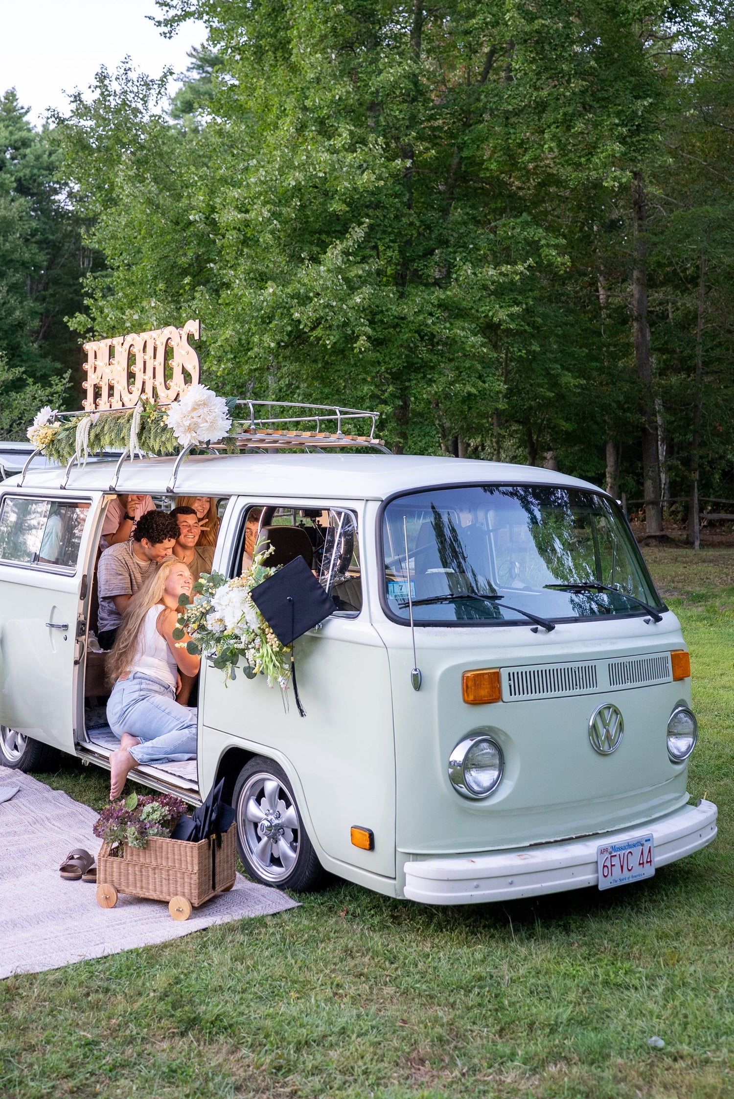 green vw bus in a field decorated for a graduation photo shoot